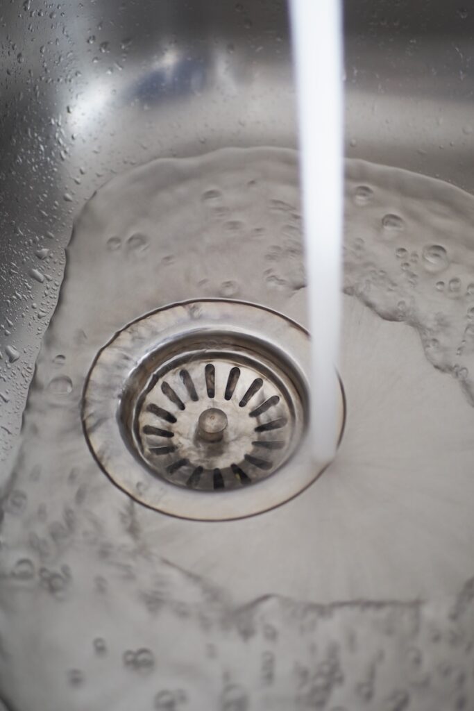 Water flowing drown drain from a faucet